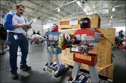 Carlo Bertocchini uses a remote control to operate Roboxers Johnny Apple Pie of the US (L) and Boris Ruski of the Soviet Union at the RoboGames in San Francisco, California, 16 June 2007.(AFP/Robyn Beck)